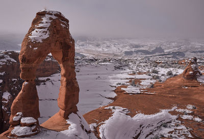 Scenic view of snowcapped landscape against sky during winter