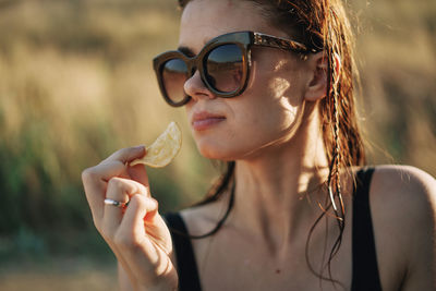 Close-up of young woman drinking water