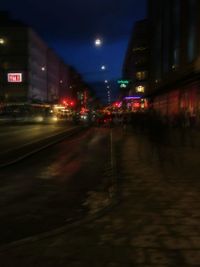 Illuminated road in city at night