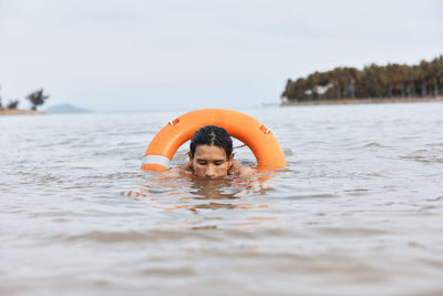 Boy swimming in sea