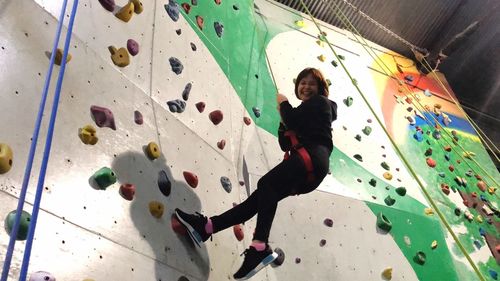 Full length portrait of man with arms raised