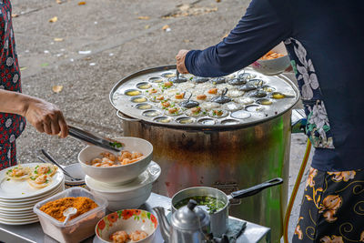 Midsection of man preparing food