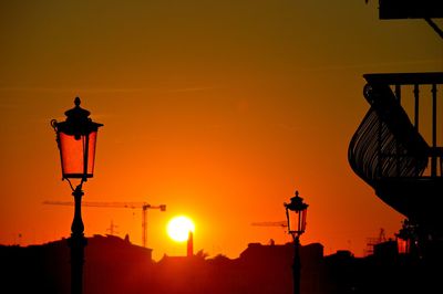 Low angle view of silhouette street light against sky at sunset