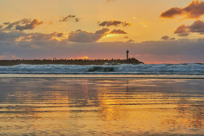 Scenic view of sea against orange sky