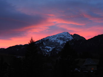 Scenic view of snowcapped mountains against sky at sunset