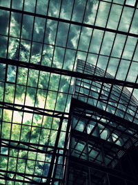 Low angle view of modern building against cloudy sky