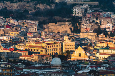 Top view of the streets of the historic center of naples with a dome illuminated by the sun