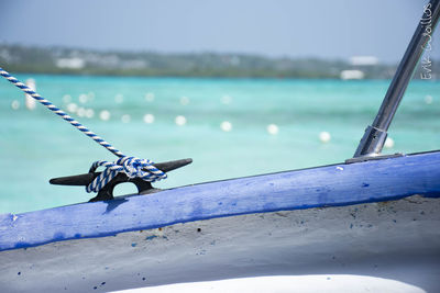 Close-up of ship on beach against sky