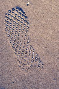 High angle view of footprints on sand