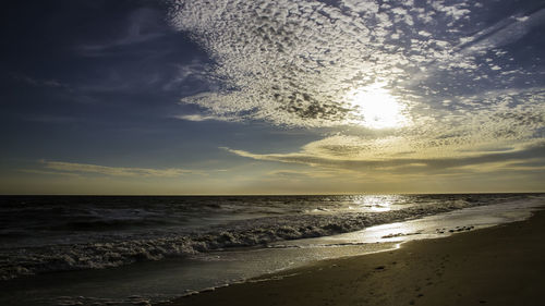 Scenic view of beach against sky during sunset