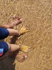 Low section of person standing on beach
