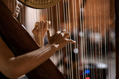 Close-up of hands playing piano