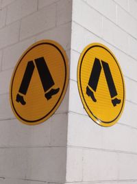 Close-up of arrow sign on wall