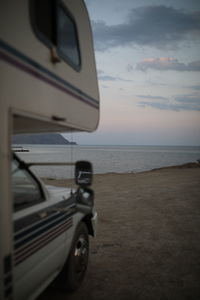 Vintage car on beach during sunset