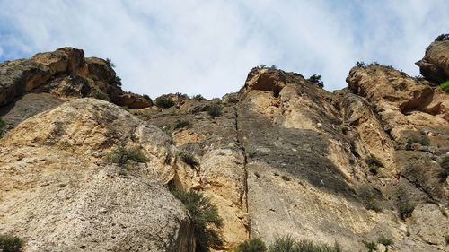 Low angle view of rock formations against sky