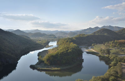 Scenic view of lake and mountains against sky