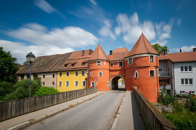 Street amidst buildings against sky