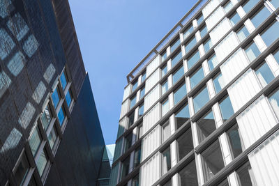 Low angle view of modern building against clear blue sky