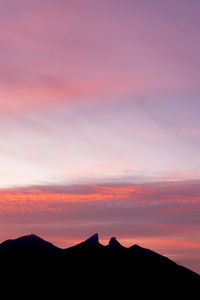 Scenic view of silhouette mountains against sky during sunset