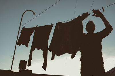 Man cleansing hanging clothes