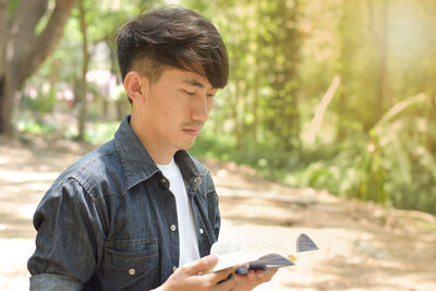 Portrait of young man holding camera