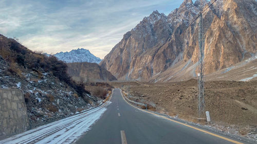 Road amidst mountains against sky