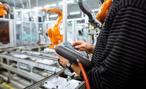 Man using mobile phone in factory