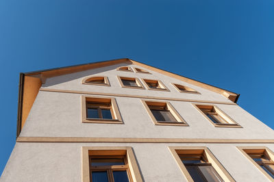 Low angle view of building against clear blue sky