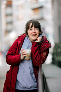 Portrait of smiling woman standing outdoors