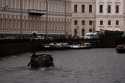 View of boats in river against buildings