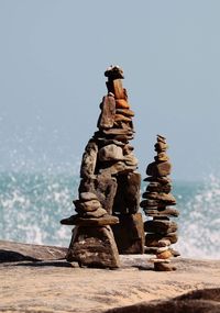Stack of rocks on shore against clear sky