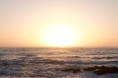 Scenic view of sea against clear sky during sunset