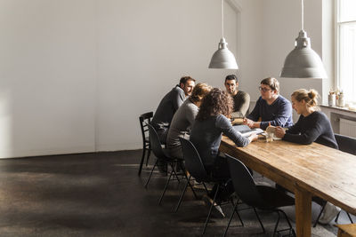 Coworkers having a meeting in modern office