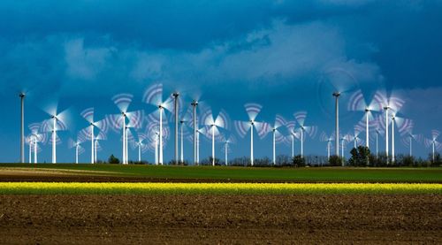 Windmills against blue sky