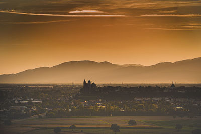 High angle view of buildings in city at sunset