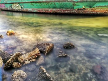 Close-up of rocks in sea against sky