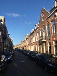 Street amidst buildings in city against sky