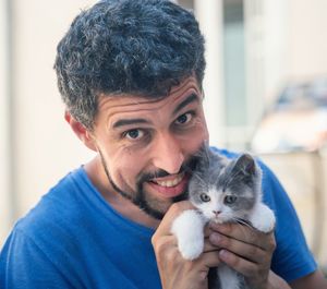 Portrait of man with kitten