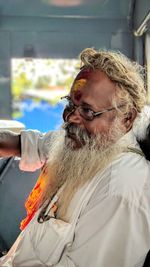 Bearded man sitting indoors