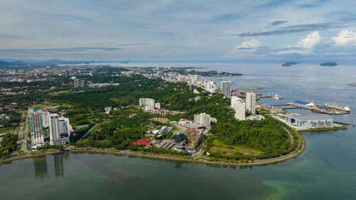 High angle view of city by sea against sky