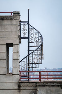 A winding metal staircase on a rooftop in portrait orientation.