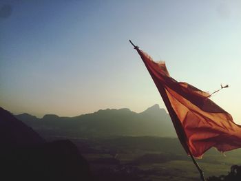 Close-up of flag against mountain range