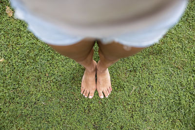 Woman standing on green grass