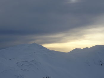 Scenic view of snowcapped mountains against sky during sunset