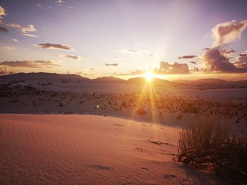 Scenic view of sunset over land