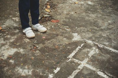 Low section of man standing on street