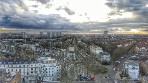 Cityscape against cloudy sky