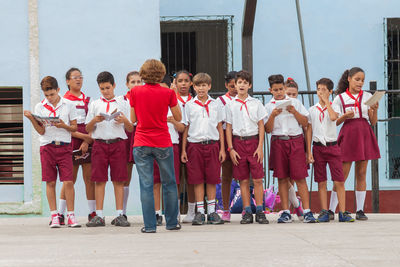 Panoramic view of people standing in front of building