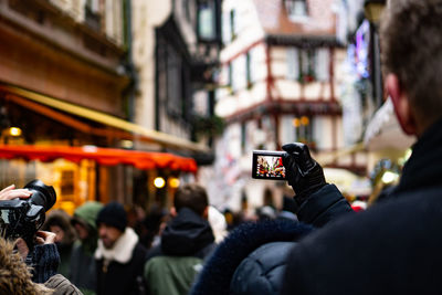 Close-up of woman holding camera