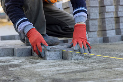 Low section of man standing on wood